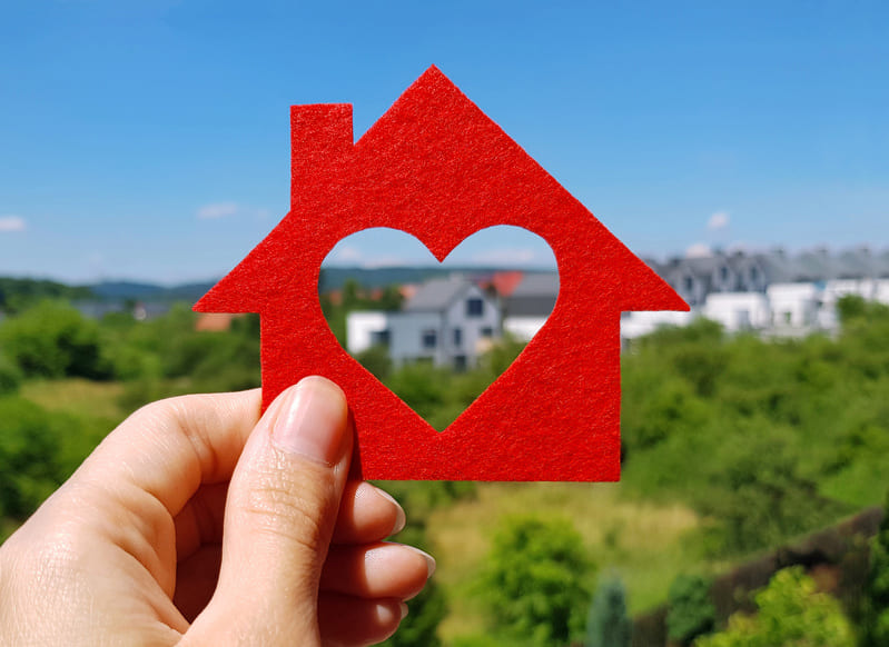 cardboard house with heart cutout in center