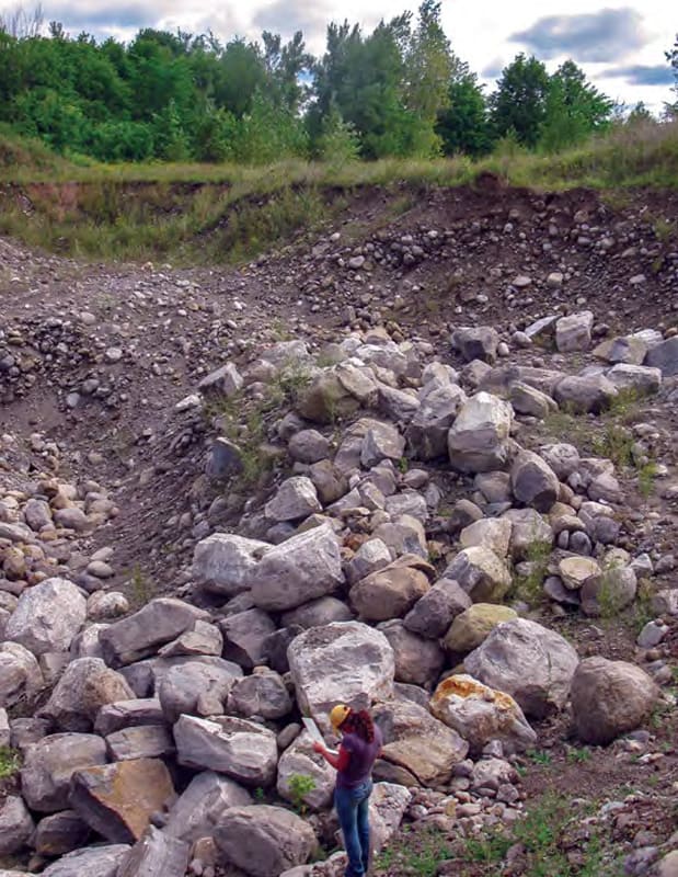 Boulders amongst sand and gravel in an esker aquifer.