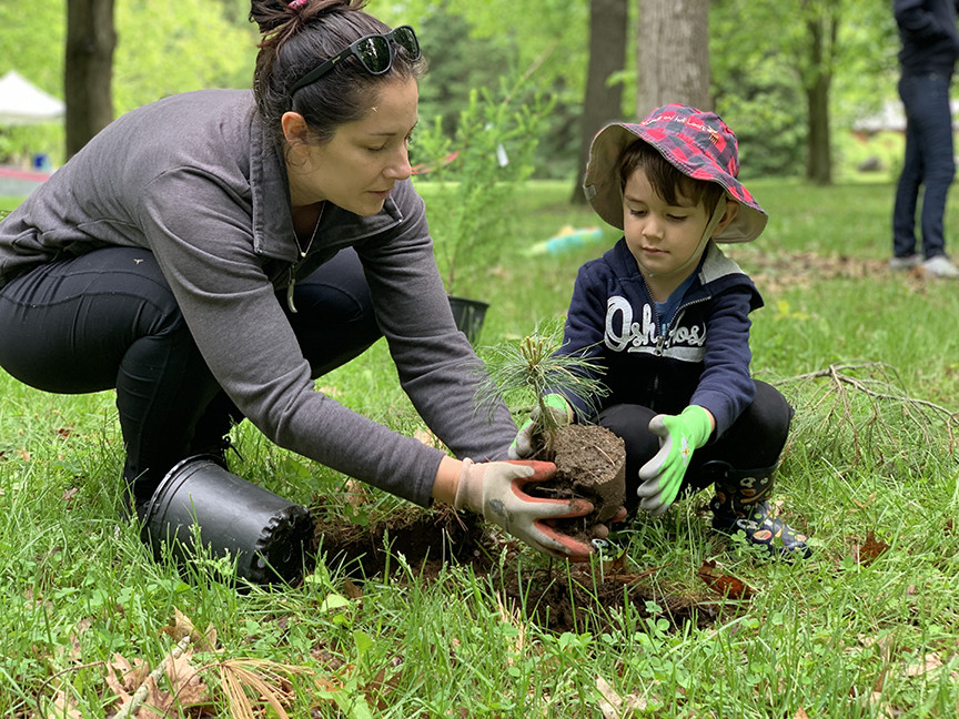 earth day - mother and son planting a tree