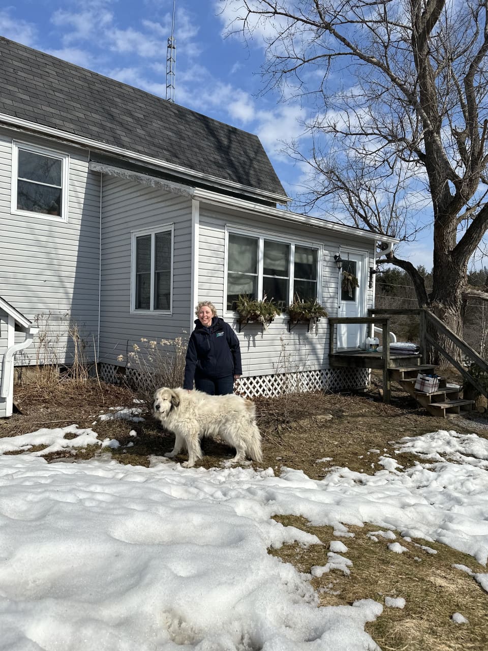 Rebecca and her dog, Beau, outside the McCann House on Foley Mountain.