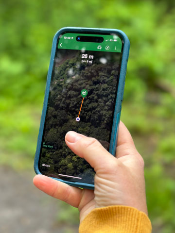 phone held up to find a geocache